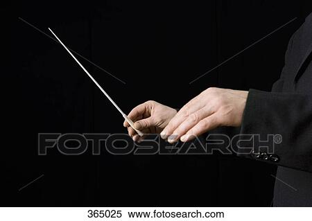 Conductor holding a baton View Large Photo Image Stock Photography - Conductor holding a baton. Fotosearch