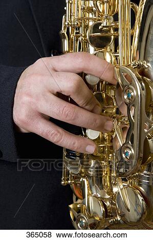 Detail of a man playing the saxophone View Large Photo Image Stock Photo - Detail of a man playing the saxophone. Fotosearch