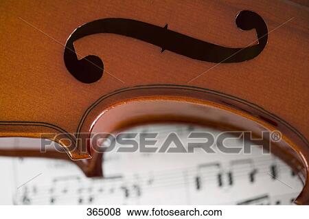 Detail of violin on sheet music View Large Photo Image Stock Photo - Detail of violin on sheet music. Fotosearch