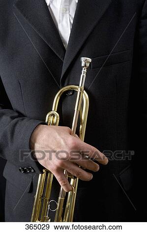 Stock Photo - Man holding a trumpet. Fotosearch