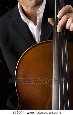 Man playing a cello View Large Photo Image Picture - Man playing a cello. Fotosearch