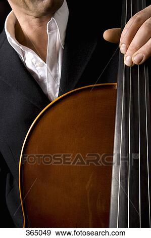 Man playing a cello View Large Photo Image Stock Photo - Man playing a cello. Fotosearch