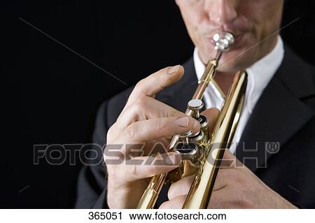 Man playing a trumpet View Large Photo Image Stock Image - Man playing a trumpet. Fotosearch