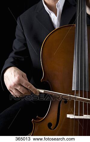 Man playing the cello View Large Photo Image Stock Image - Man playing the cello. Fotosearch