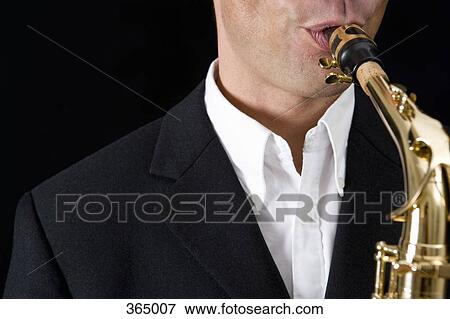 Man playing the saxophone View Large Photo Image Stock Photo - Man playing the saxophone. Fotosearch