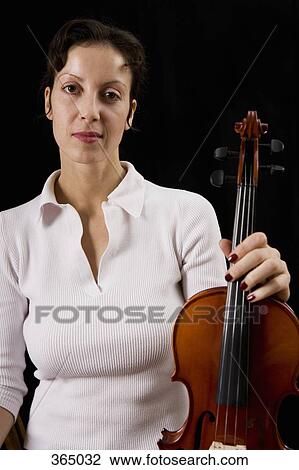 Woman holding a violin View Large Photo Image Stock Image - Woman holding a violin. Fotosearch