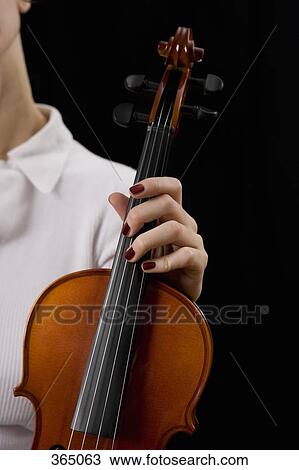 Woman holding a violin View Large Photo Image Stock Image - Woman holding a violin. Fotosearch