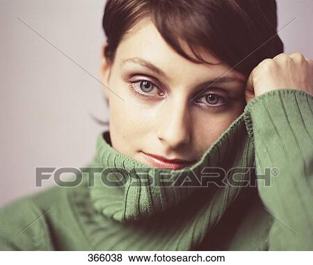 Stock Photo - Portrait of a woman wearing a green turtleneck sweater. Fotosearch