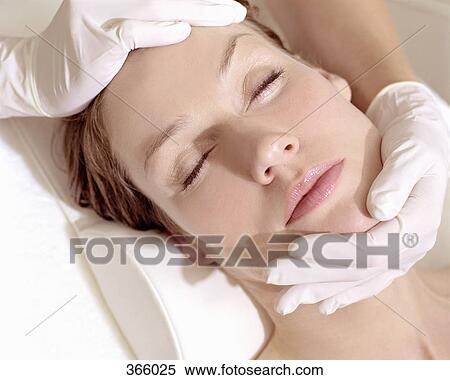 Surgeon examining woman’s face View Large Photo Image Stock Photography - Surgeon examining woman’s face. Fotosearch