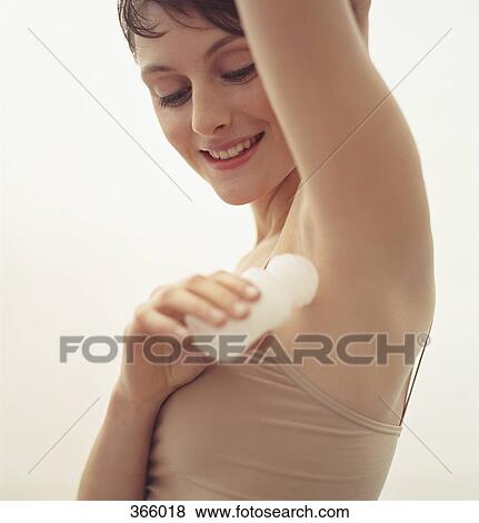 Woman applying deodorant View Large Photo Image Stock Photo - Woman applying deodorant. Fotosearch