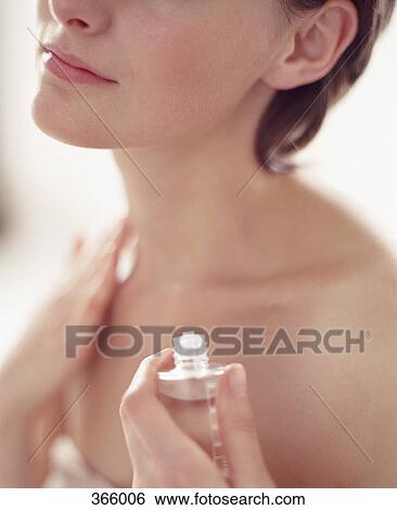 Woman applying essential oil to skin View Large Photo Image Stock Photograph - Woman applying essential oil to skin. Fotosearch