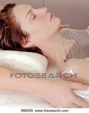 Stock Photo - Woman having body mask at beauty spa. Fotosearch