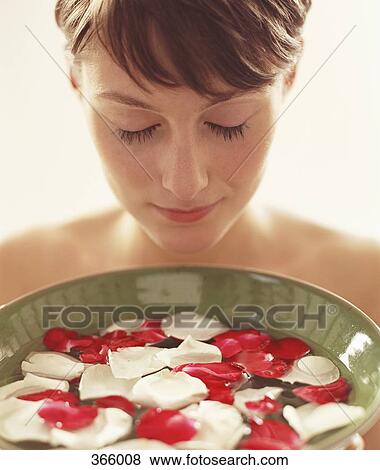 Woman holding a bowl of water with rose petals View Large Photo Image Stock Photo - Woman holding a bowl of water with rose petals. Fotosearch
