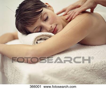 Stock Image - Woman receiving a massage at a beauty spa. Fotosearch