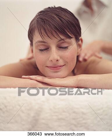 Stock Image - Woman receiving a massage at a beauty spa. Fotosearch