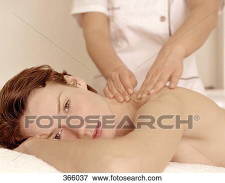 Stock Photo - Woman receiving a massage at a beauty spa. Fotosearch