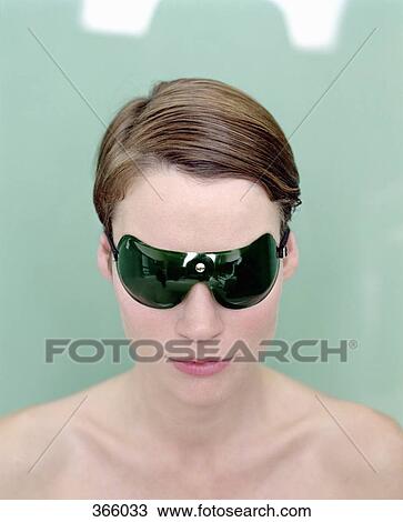 Stock Image - Woman wearing protective eyewear at beauty spa. Fotosearch