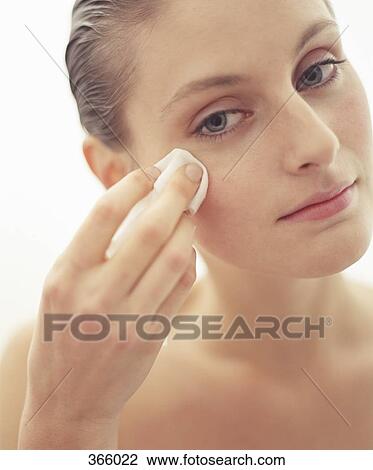 Young woman holding tissue on cheek View Large Photo Image Stock Image - Young woman holding tissue on cheek. Fotosearch