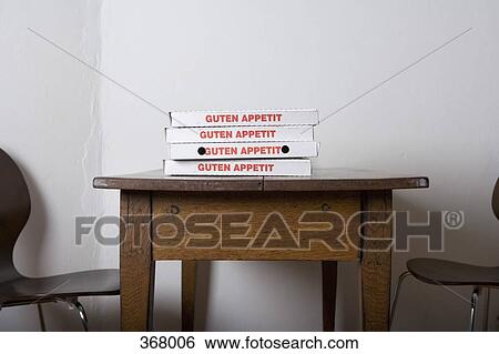 Stock Photograph - Pizza boxes stacked on a table. Fotosearch