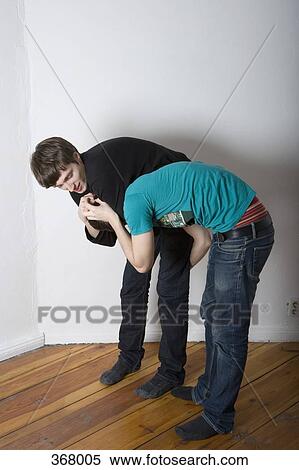 Two young men play fighting View Large Photo Image Stock Photography - Two young men play fighting. Fotosearch