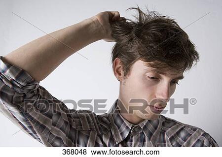 Young man looking tired with messy hair View Large Photo Image Stock Photo - Young man looking tired with messy hair. Fotosearch