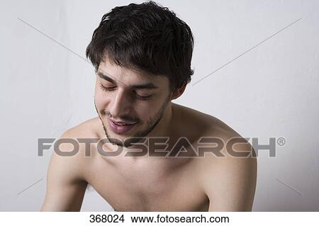Young man sitting shirtless View Large Photo Image Picture - Young man sitting shirtless. Fotosearch