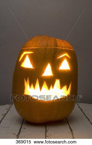 Illuminated Jack O’Lantern on a table View Large Photo Image Stock Photography - Illuminated Jack O’Lantern on a table. Fotosearch