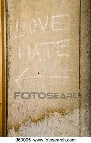 Stock Photography - ‘Love’ and ‘Hate’ written in chalk on a wall. Fotosearch