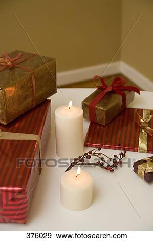 Presents and Christmas decorations on a table View Large Photo Image Stock Photo - Presents and Christmas decorations on a table. Fotosearch