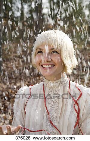 Snow falling on young woman View Large Photo Image Stock Photograph - Snow falling on young woman. Fotosearch
