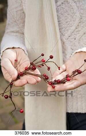 Woman holding Christmas berry decoration View Large Photo Image Stock Photography - Woman holding Christmas berry decoration. Fotosearch