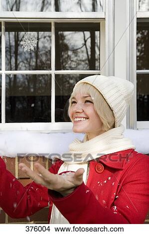 Young woman standing in the snow View Large Photo Image Picture - Young woman standing in the snow. Fotosearch