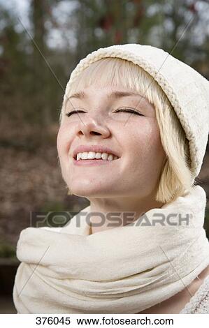 Young woman standing outside with eyes closed View Large Photo Image Stock Photography - Young woman standing outside with eyes closed. Fotosearch