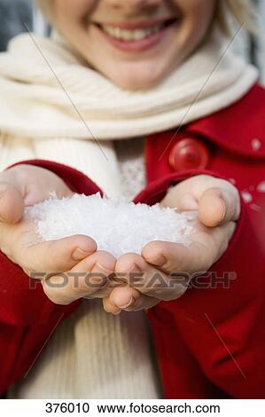 Young woman with a handful of snow View Large Photo Image Stock Image - Young woman with a handful of snow. Fotosearch