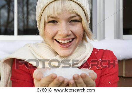 Young woman with a handful of snow View Large Photo Image Stock Photo - Young woman with a handful of snow. Fotosearch