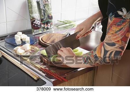 Woman preparing sushi with tattooed arm View Large Photo Image Stock Photo - Woman preparing sushi with tattooed arm. Fotosearch