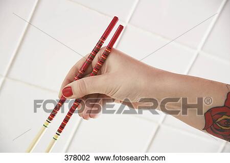 Woman’s hand holding chopsticks View Large Photo Image Stock Image - Woman’s hand holding chopsticks. Fotosearch
