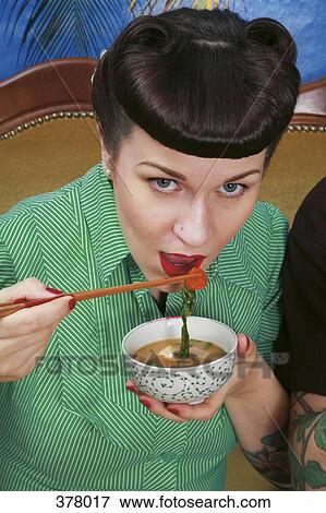 Young rockabilly woman eating miso soup View Large Photo Image Stock Photo - Young rockabilly woman eating miso soup. Fotosearch