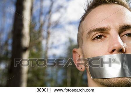 Man in the woods with adhesive tape covering his mouth View Large Photo Image Stock Image - Man in the woods with adhesive tape covering his mouth. Fotosearch