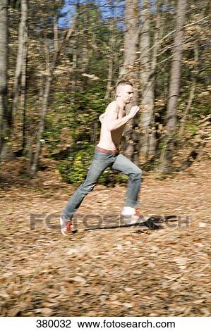 Man running through the woods View Large Photo Image Stock Image - Man running through the woods. Fotosearch