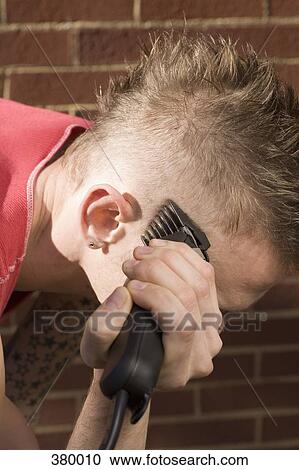 Man shaving his head with an electric razor View Large Photo Image Stock Image - Man shaving his head with an electric razor. Fotosearch