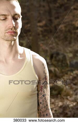 Man standing in the woods and looking down View Large Photo Image Stock Image - Man standing in the woods and looking down. Fotosearch