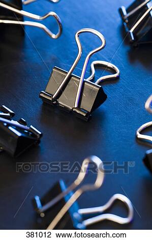 Binder clips on a desk View Large Photo Image Stock Image - Binder clips on a desk. Fotosearch