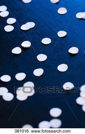 Round waste paper from a hole puncher View Large Photo Image Stock Photograph - Round waste paper from a hole puncher. Fotosearch