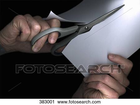 Stock Image - Man cutting paper with scissors. Fotosearch