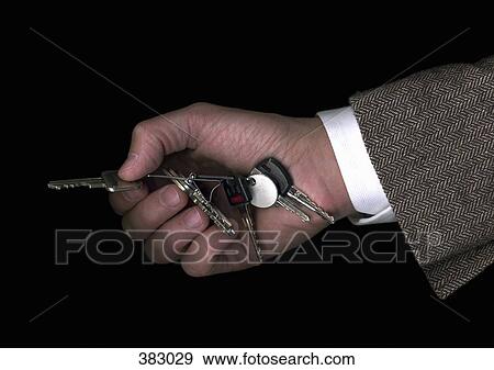 Stock Photo - Man holding a set of keys. Fotosearch