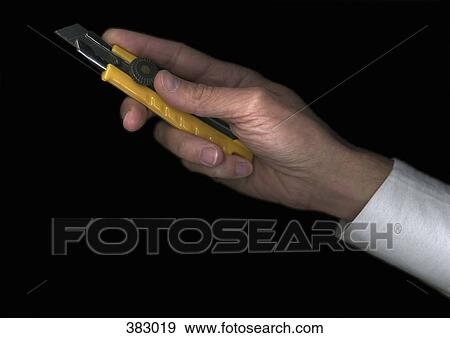 Man holding a utility knife View Large Photo Image Stock Photo - Man holding a utility knife. Fotosearch