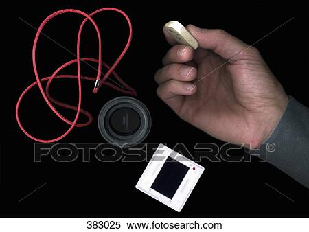 Man holding an eraser next to photographic equipment View Large Photo Image Stock Photography - Man holding an eraser next to photographic equipment. Fotosearch