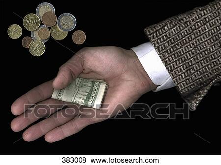 Man holding US banknotes beside pile of Euro coins View Large Photo Image Stock Photo - Man holding US banknotes beside pile of Euro coins. Fotosearch