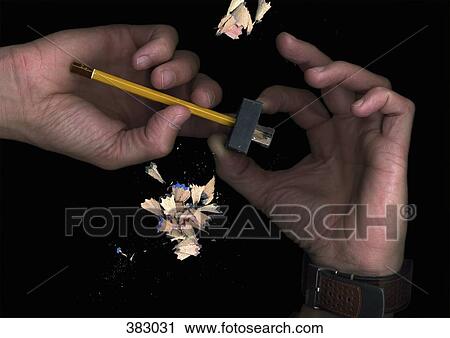 Stock Image - Man sharpening a pencil. Fotosearch